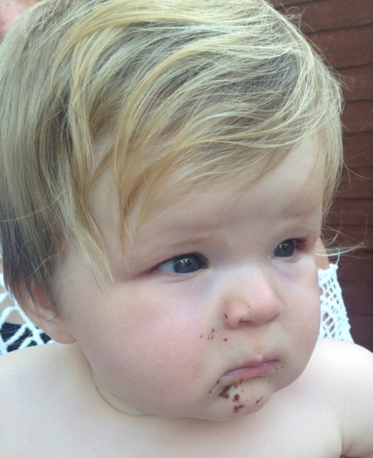 Baby with chocolate cake face