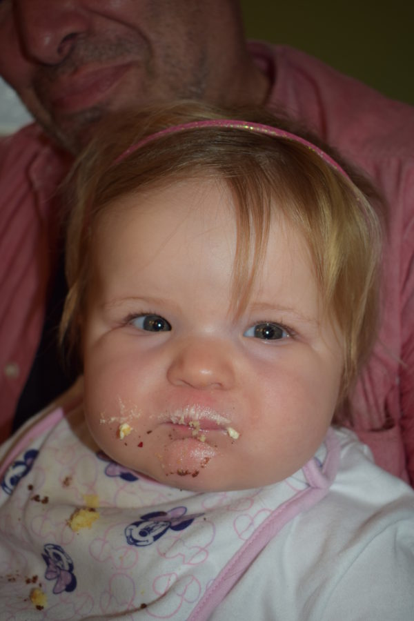 Baby with cake on her face