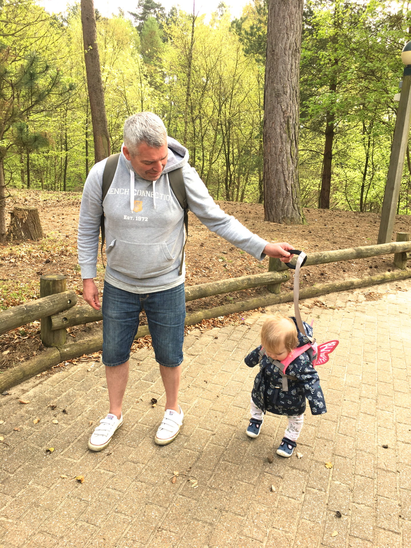 toddler walking with daddy at Center Parcs Elveden Forest