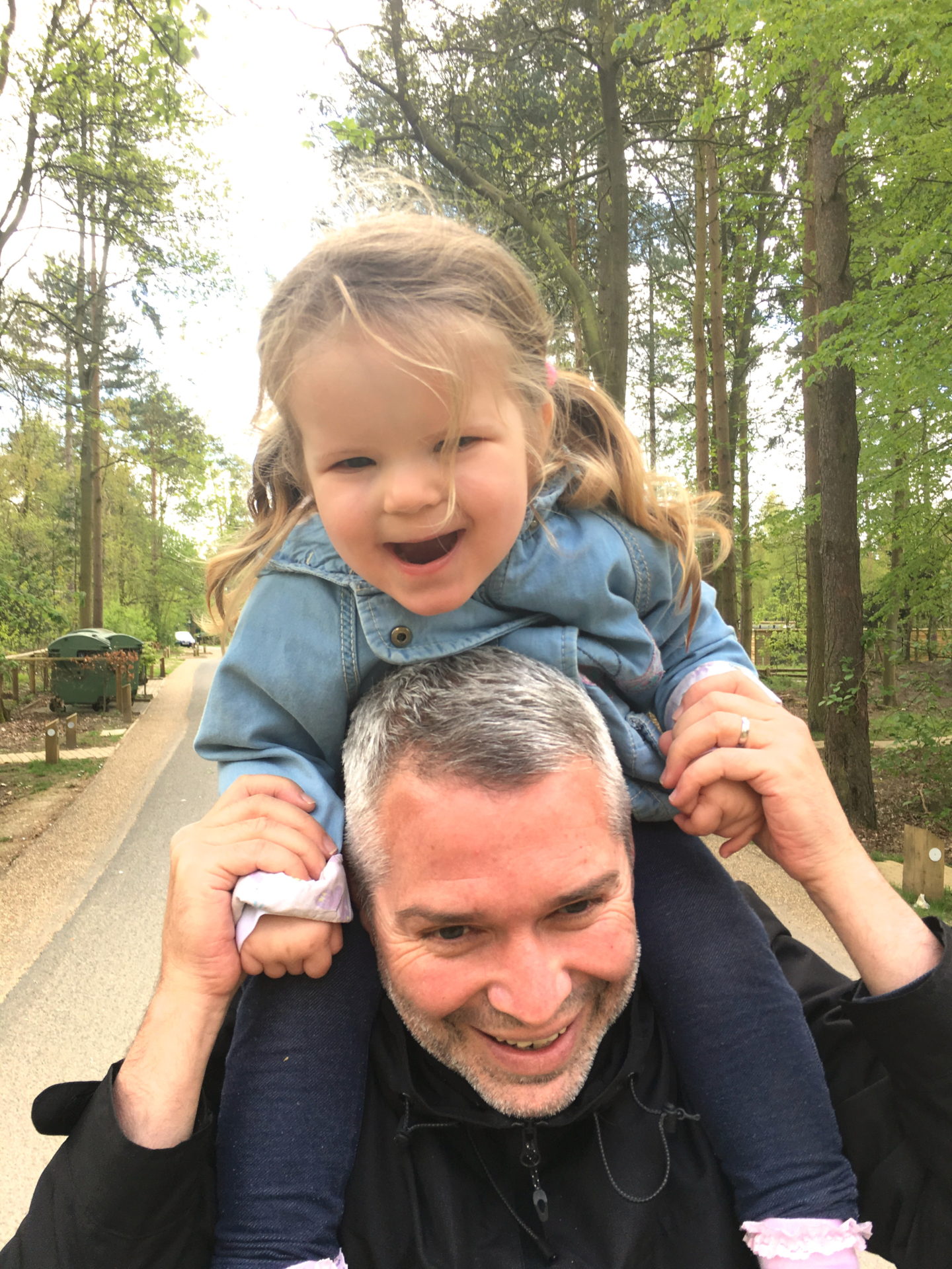 two year old sitting on dad's shoulders at Center Parcs Elveden Forest
