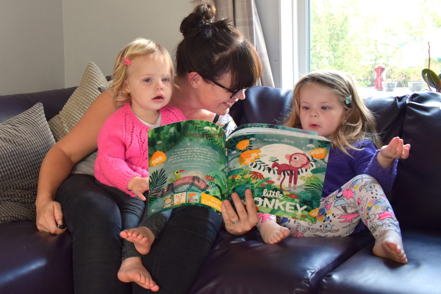 Mother sitting with two preschoolers reading - time to read