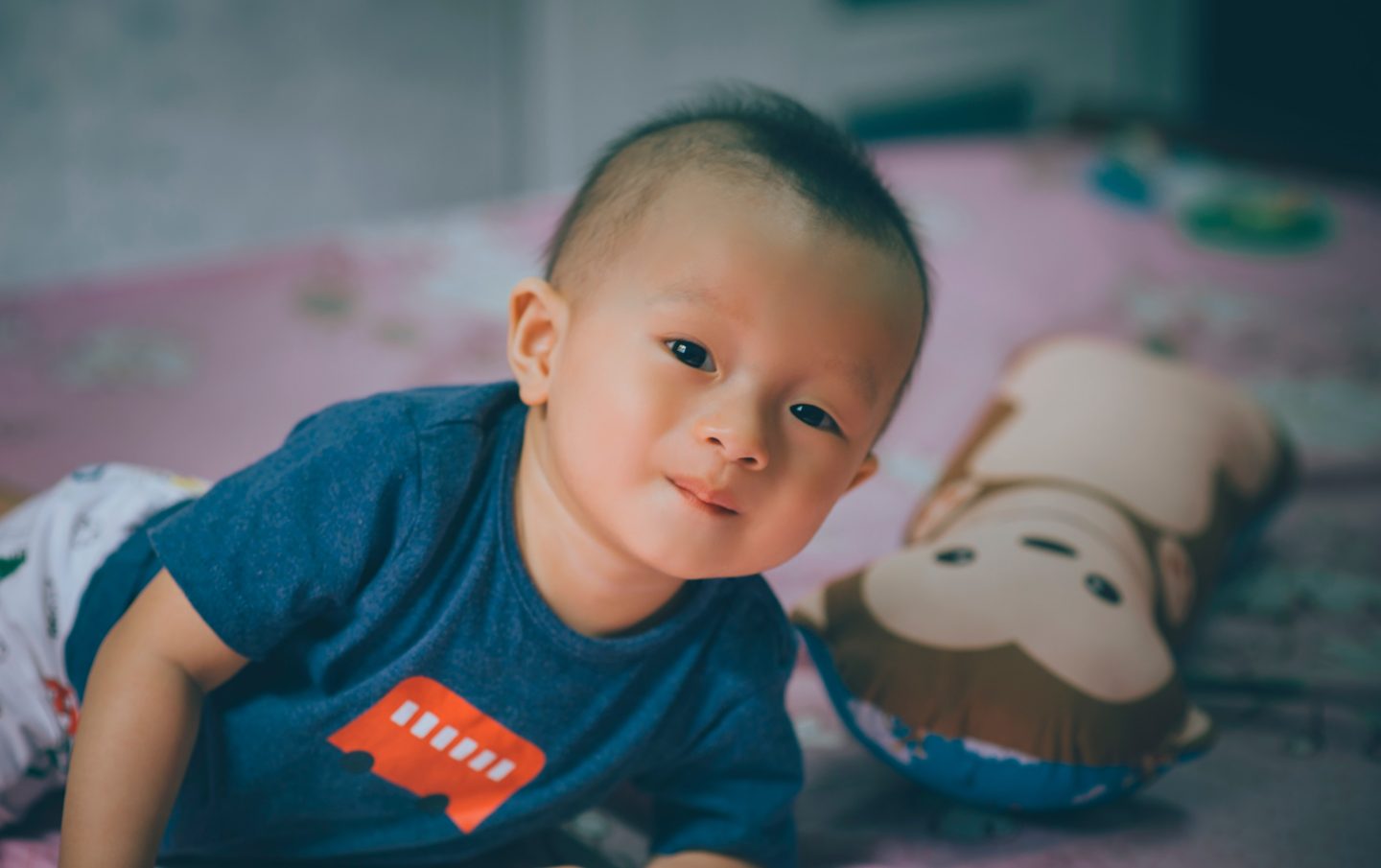 baby boy, lying on bed with teddy, smiling - when kids share a room