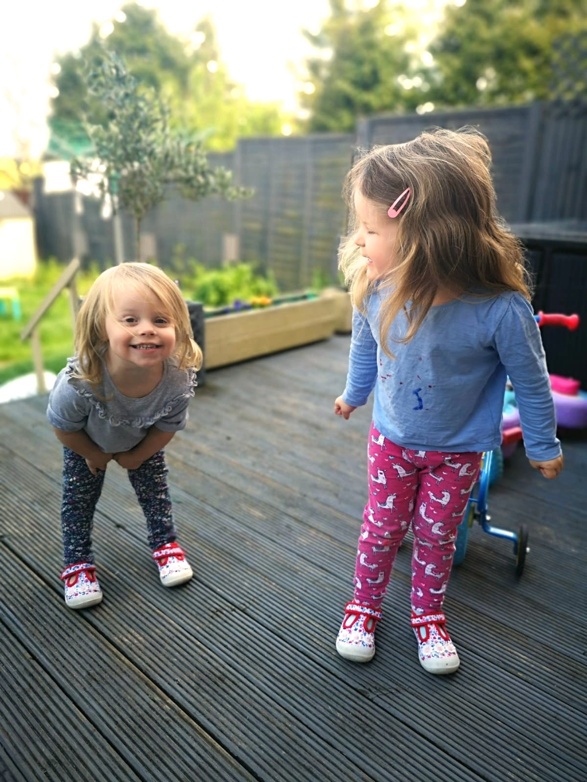 two young sisters playing in the garden